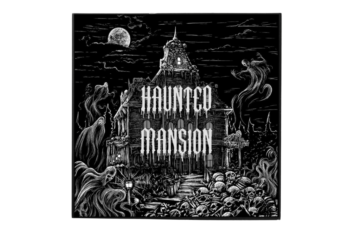 Haunted Mansion perfume label featuring a black and white haunted castle illustration with ghosts, moon, and skulls