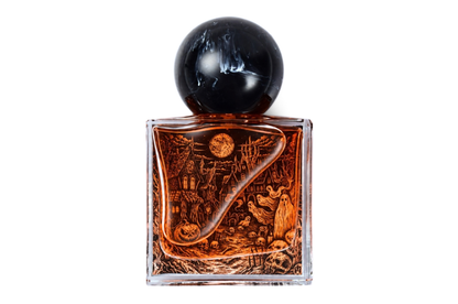 ALL HALLOWS' EVE parfum in a clear square glass bottle with amber liquid, black spherical cap, and Halloween scene