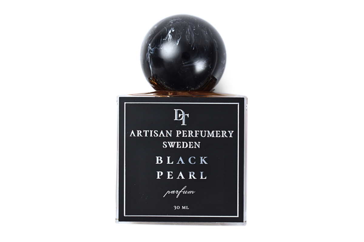Black Pearl parfum bottle in black glass with a glossy spherical cap and minimalist white lettering