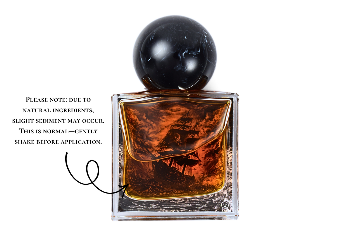 Black Pearl parfum bottle with amber liquid, clear square glass, black spherical cap, and pirate ship illustration