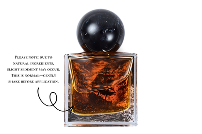 Black Pearl parfum bottle with amber liquid, clear square glass, black spherical cap, and pirate ship illustration