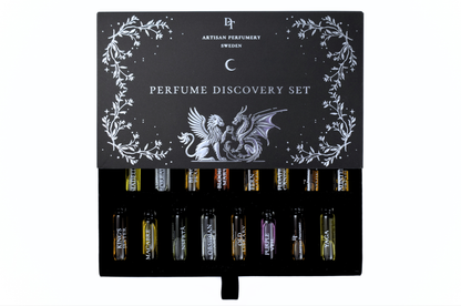 Discovery Set black parfum sample box with silver botanical and dragon artwork, holding sixteen assorted 1 ml vials