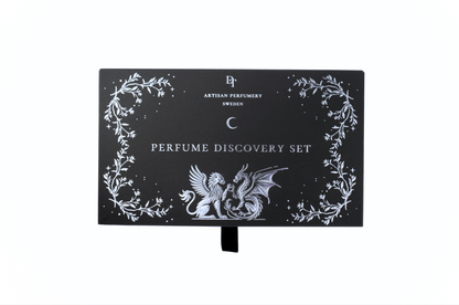 Discovery Set black perfume sample gift box with white botanical border, gothic dragon artwork, and pull ribbon