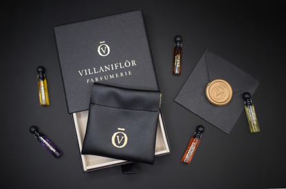 Discovery Set perfume samples in five slim glass vials with a charcoal box, black fabric pouch and gold branding