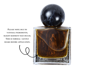 Floating Candles amber parfum in a clear square glass bottle with a black marbled spherical cap and artwork