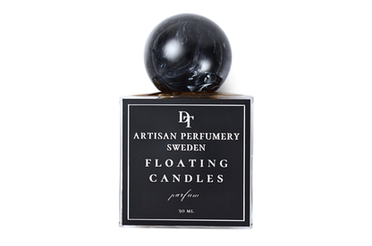 Floating Candles 30 ml parfum in a clear square bottle with black label and glossy black marbled sphere cap
