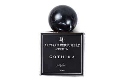 Gothika black glass parfum bottle with glossy spherical cap, white label, and 30 ml volume