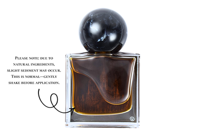 Gothika parfum bottle with dark amber liquid, clear glass, black spherical cap, and gothic cathedral design