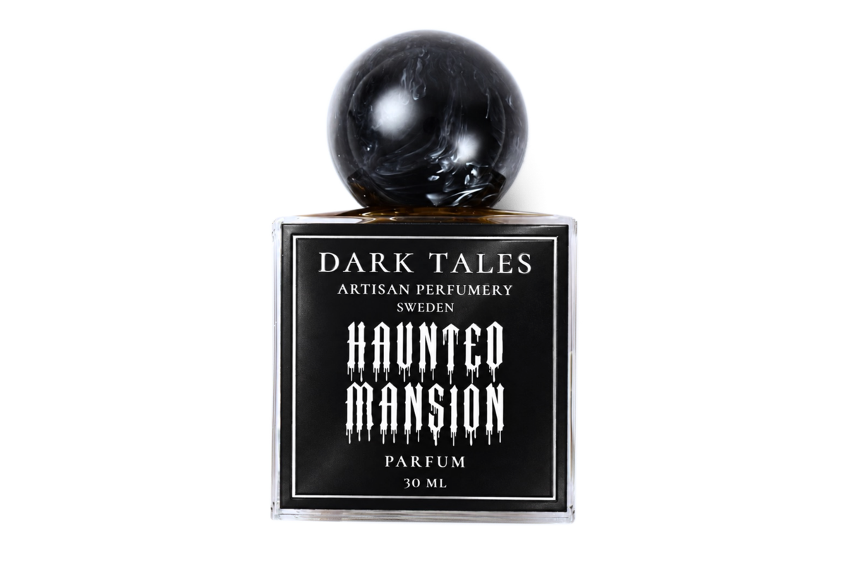 Haunted Mansion parfum in a clear square glass bottle with black label and glossy black spherical cap