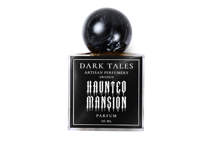 Haunted Mansion parfum in a clear square glass bottle with black label and glossy black spherical cap