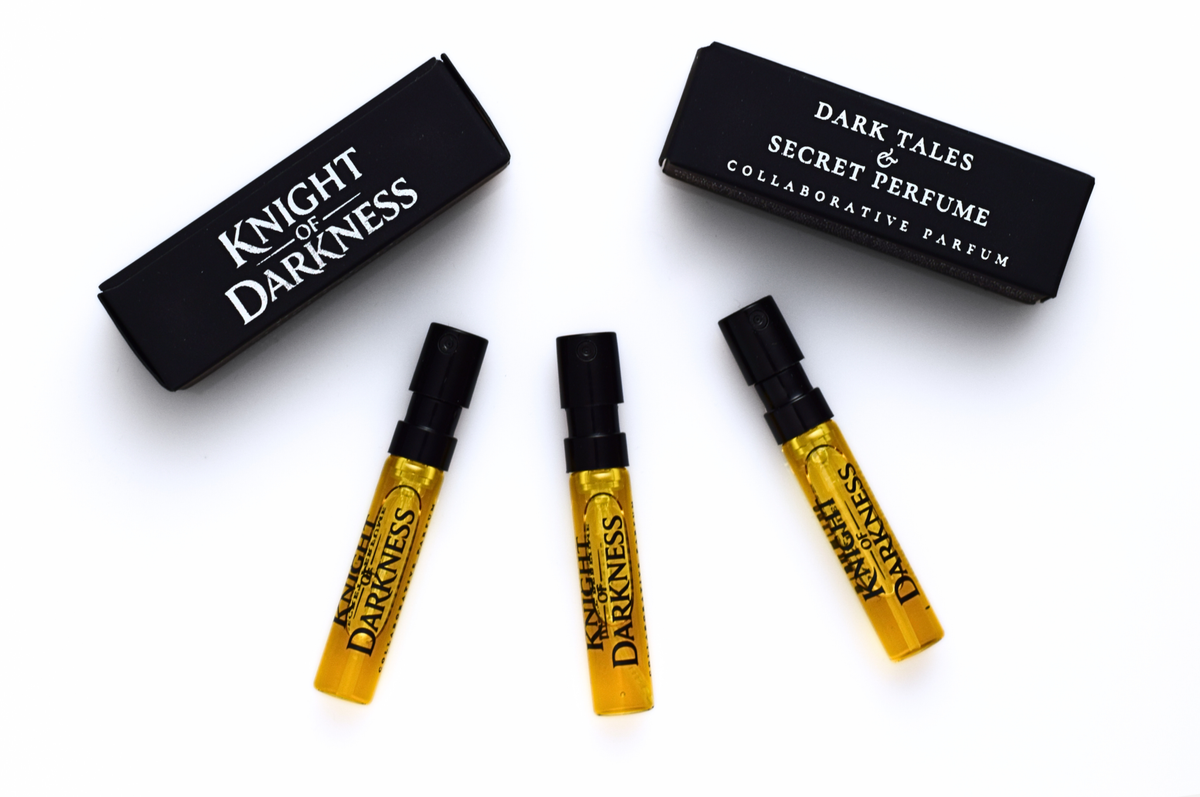 Knight of Darkness parfum samples in amber glass vials with black caps and branded black presentation boxes