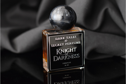 Knight of Darkness parfum in a clear glass bottle with amber liquid, black label, and glossy marbled sphere cap