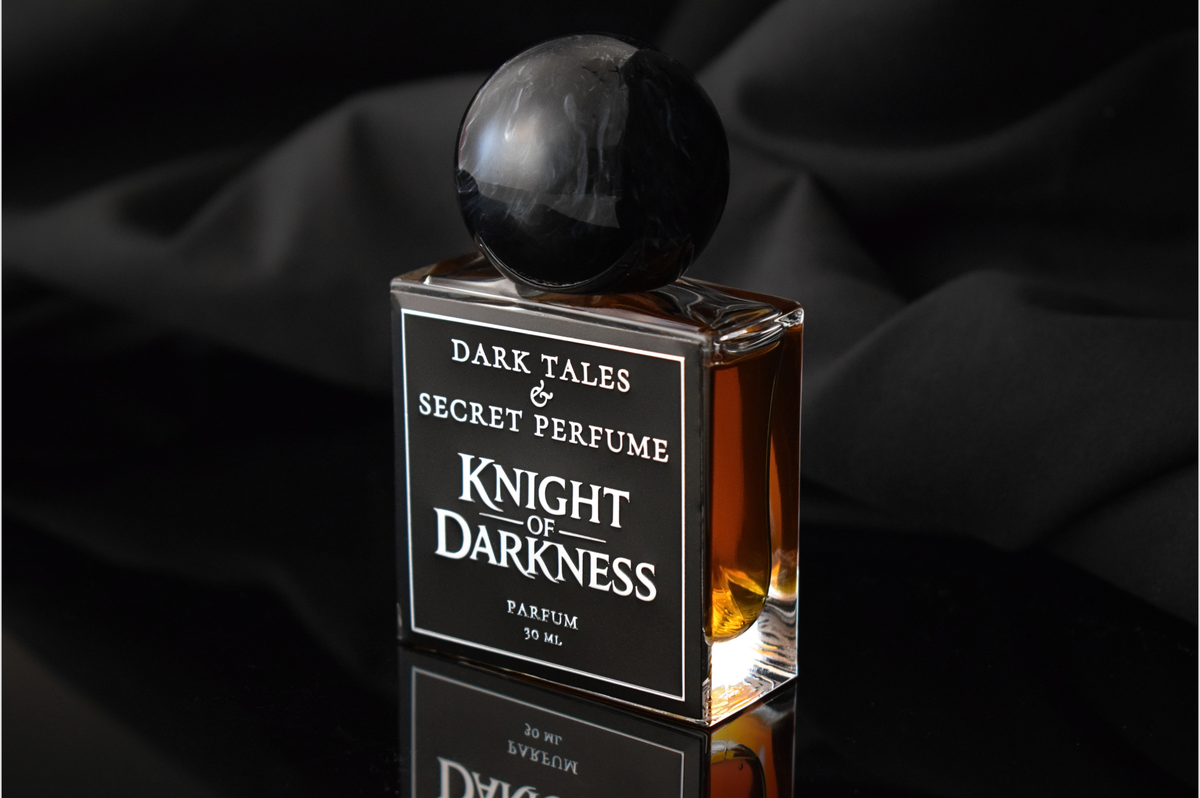 Knight of Darkness parfum bottle with amber liquid, black marble sphere cap, and bold black label