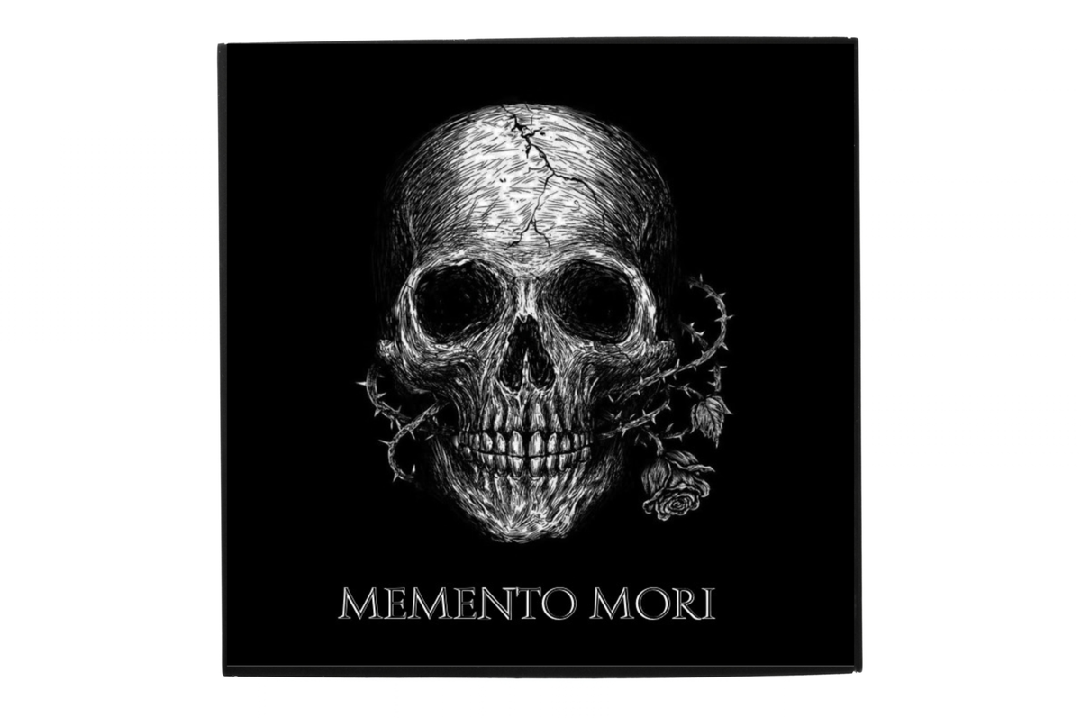 MEMENTO MORI gothic artwork featuring a detailed white skull, thorny vine, rose, and silver lettering on black