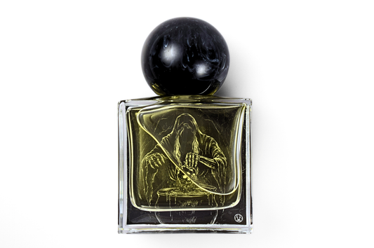 Obsidian Apple parfum in a clear square glass bottle with dark amber liquid, black marble-effect round cap, and etched hooded figure