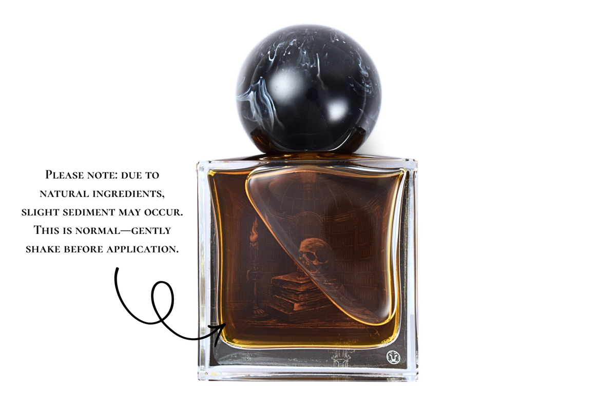 Old Library parfum bottle with amber liquid, clear glass, black marble-patterned cap, and illustrated book design