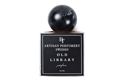 Old Library parfum bottle with black label, clear glass, dark liquid, and glossy black spherical cap