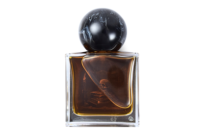 Old Library parfum bottle with amber liquid, clear glass, black marble-patterned round cap, and illustrated book design