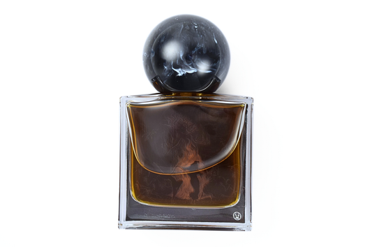 WITCHING HOUR parfum in a clear square glass bottle with dark amber liquid and a black marbled spherical cap